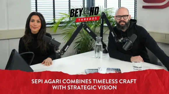Two people sit at a table with microphones, glassware, and magazines, recording a podcast episode titled "Sepi Agari Combines Timeless Craft With Strategic Vision.